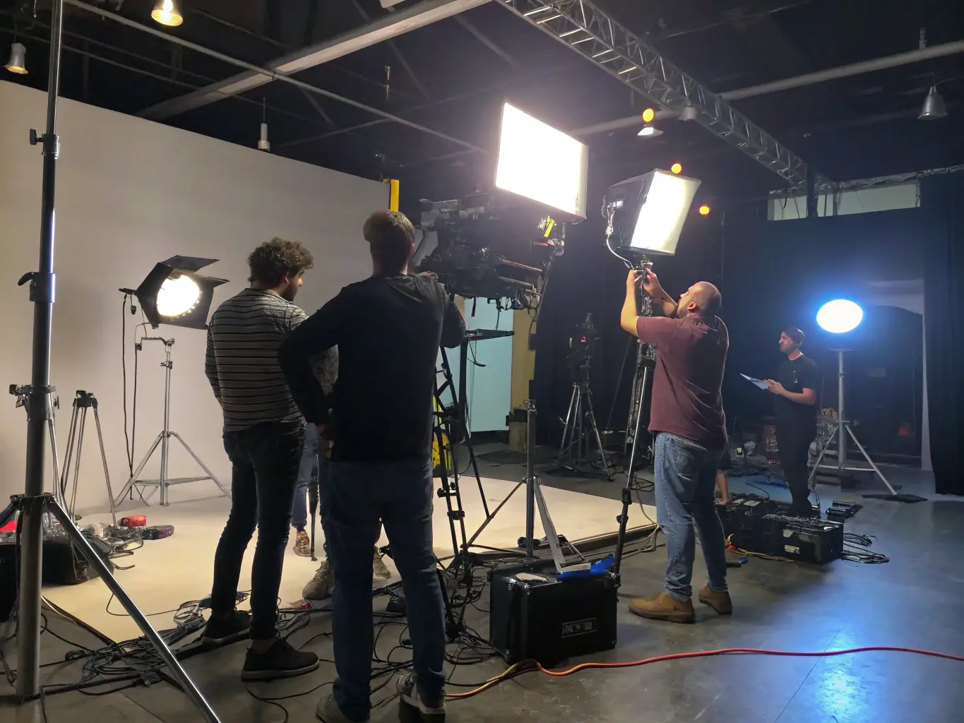 A behind-the-scenes image of a film production, featuring crew members working with actors and equipment, illustrating the audiovisual production support provided by ASS NUCLEAR ZONE.